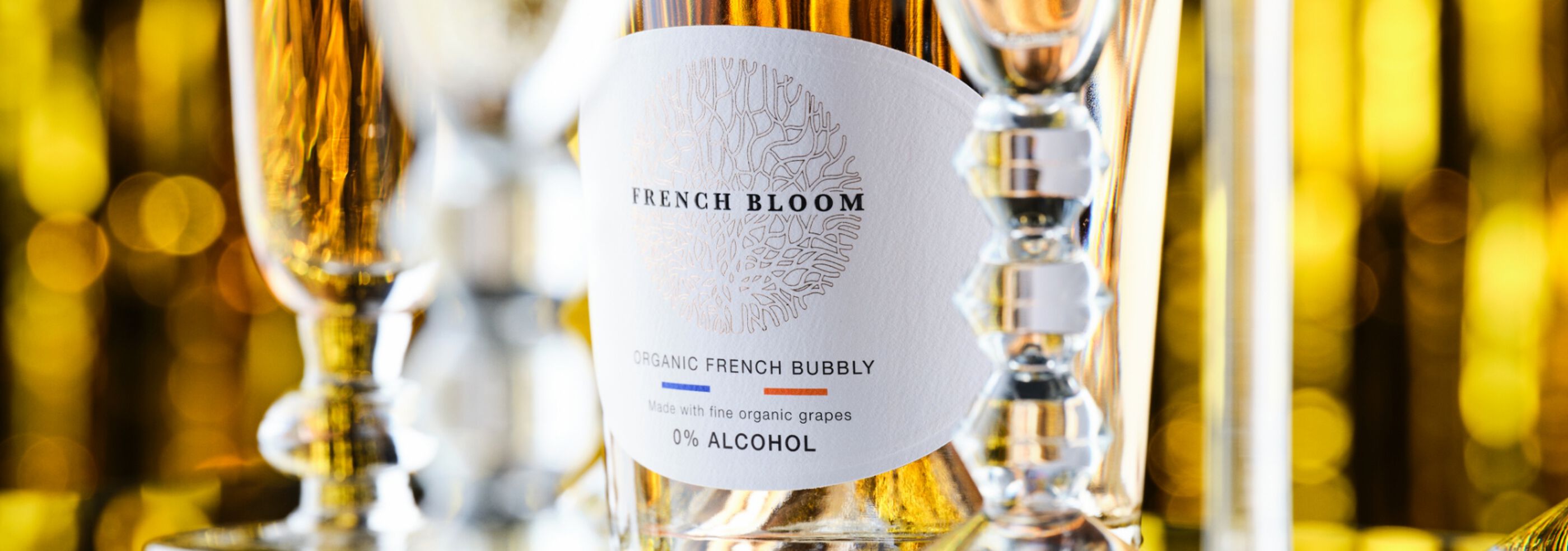 Close up of bottle of French Bloom with glassware